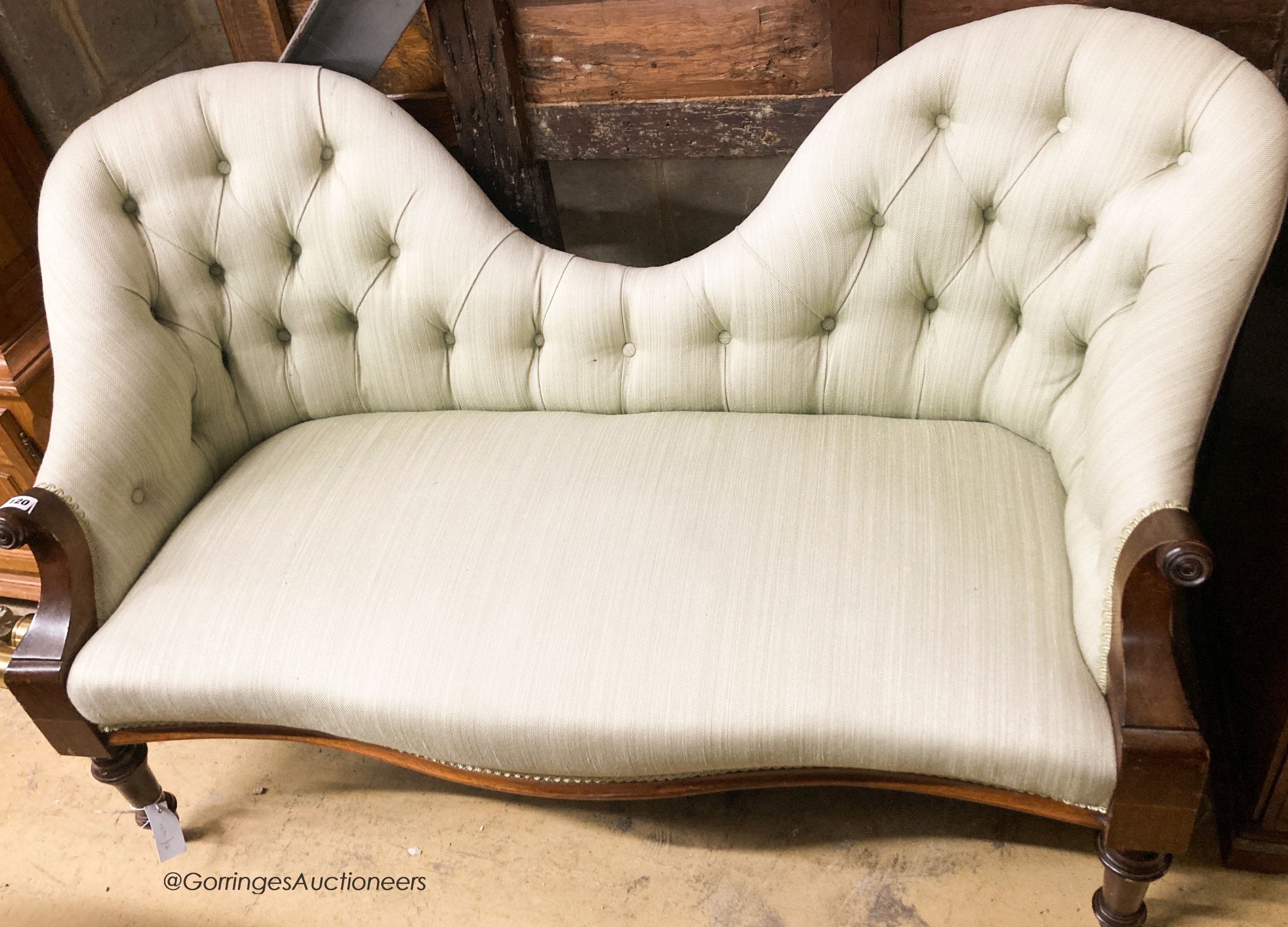 A Victorian mahogany double spoon back settee upholstered in buttoned green fabric, width 130cm, depth 58cm, height 76cm